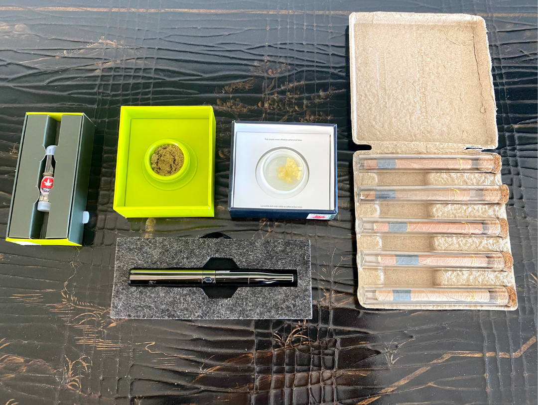 A photo of cannabis concentrates wax, THC distillate and kief next to pre-rolls and a vape.