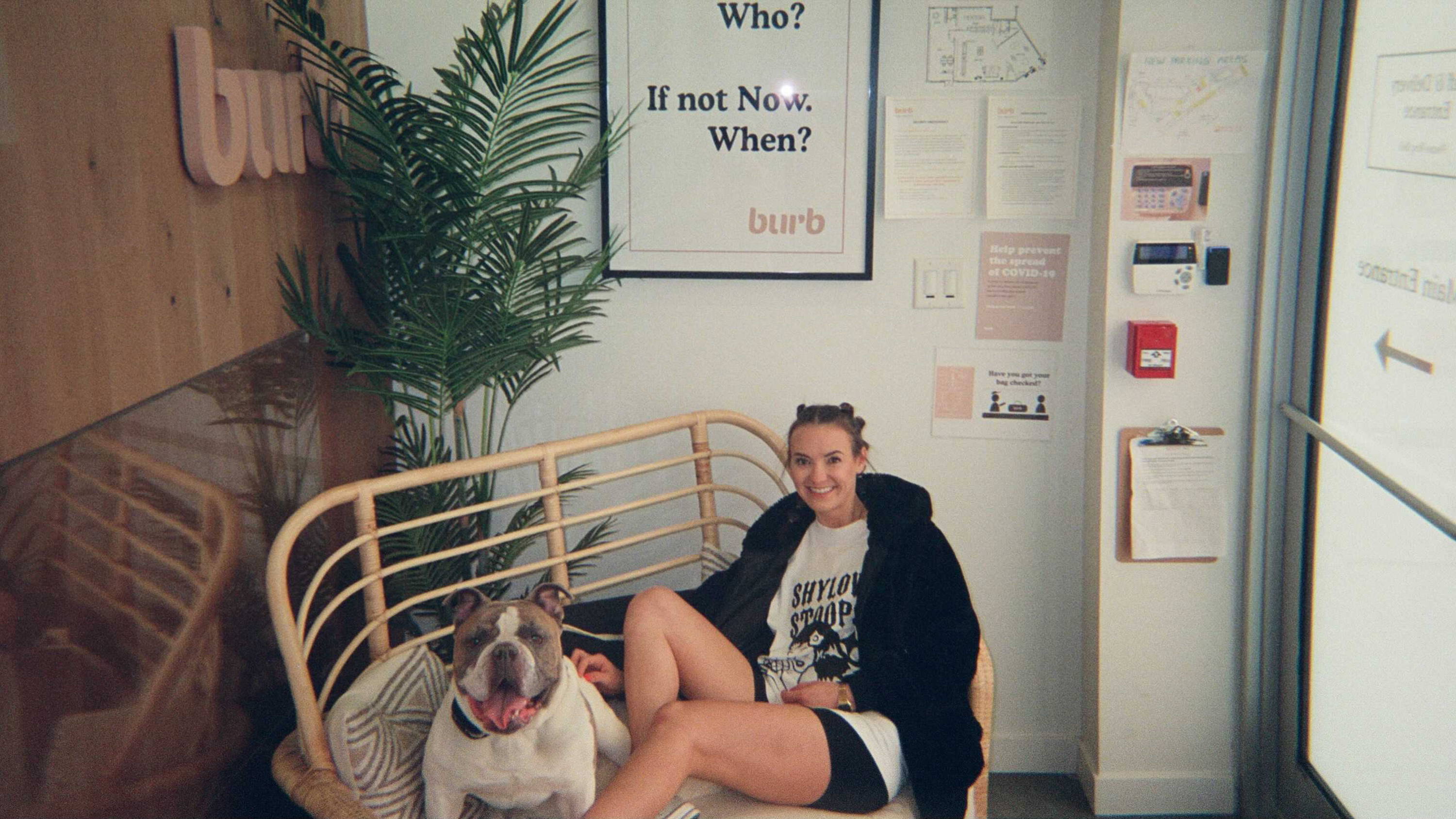 A photo of one of our burbtenders with their dog sitting on a couch at our Broadway location.