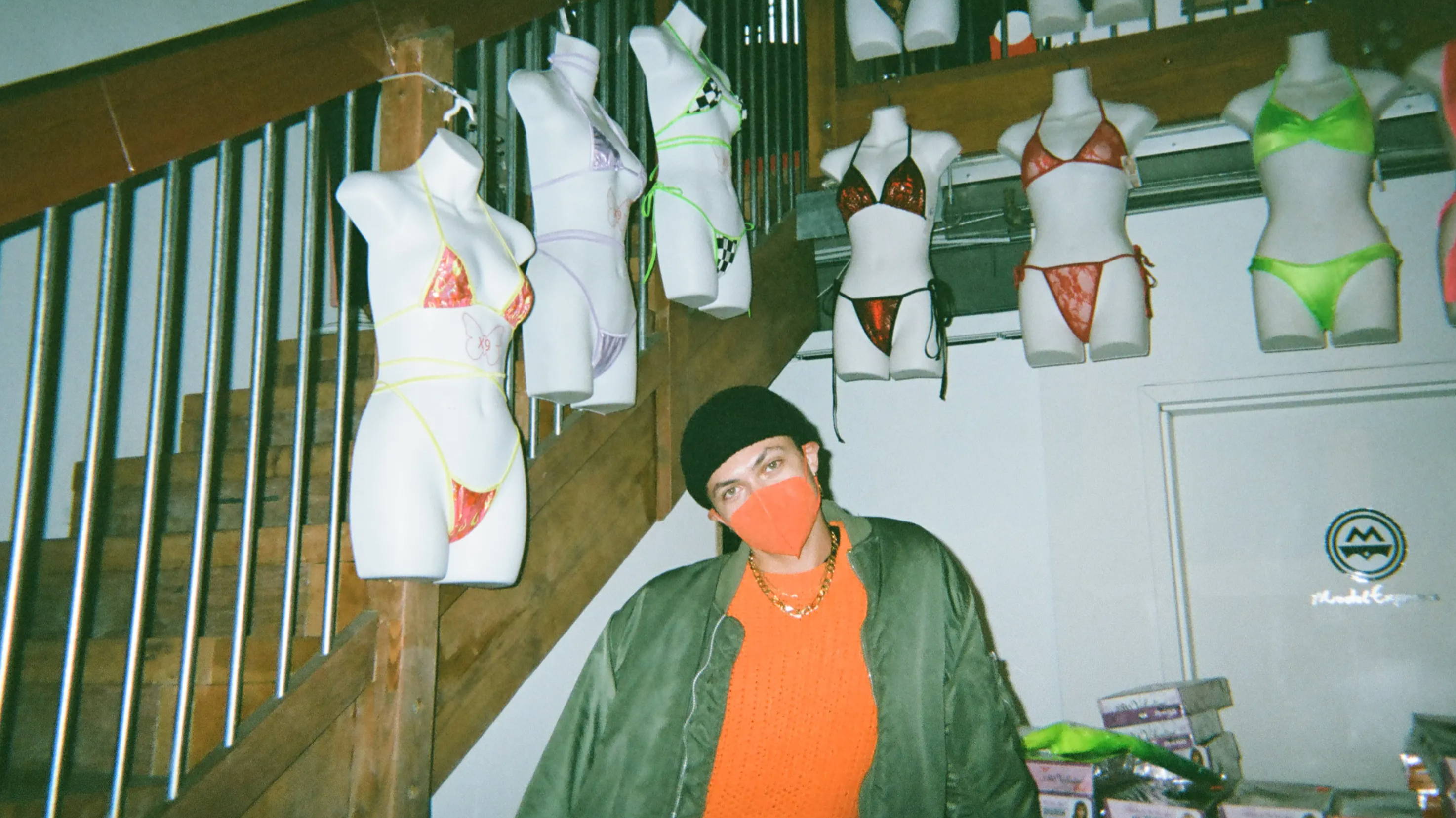 A photo of Venus inside Model Express with bikini's from X9 Bikini Shop behind her.