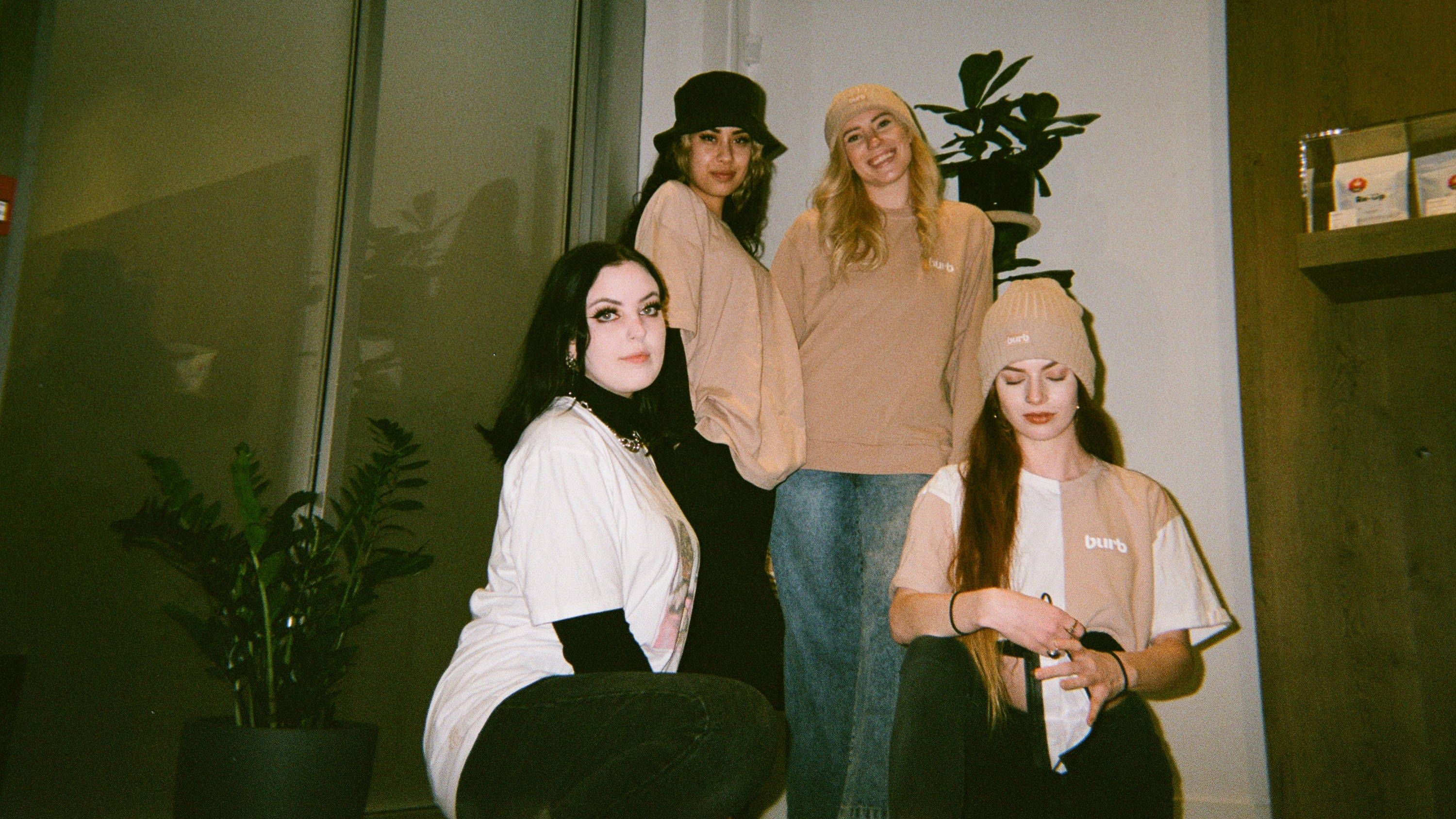 A photo of four women from Burb cannabis with the store behind them.